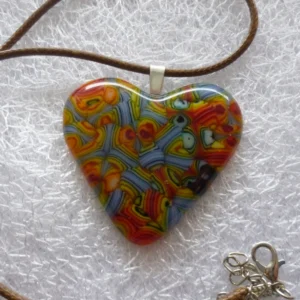 Heart pendant, in multicolours with sterling silver bail and hangs from a brown cord necklace.