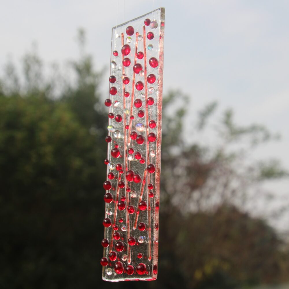 View of suncatcher at an angle with red and dichroic beads.