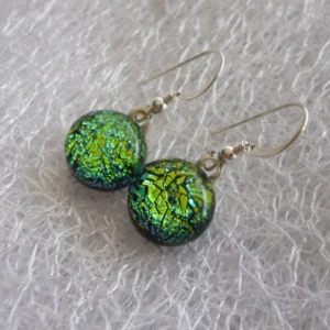 Green earrings of dichroic glass with 925 sterling silver ear wires at an angle