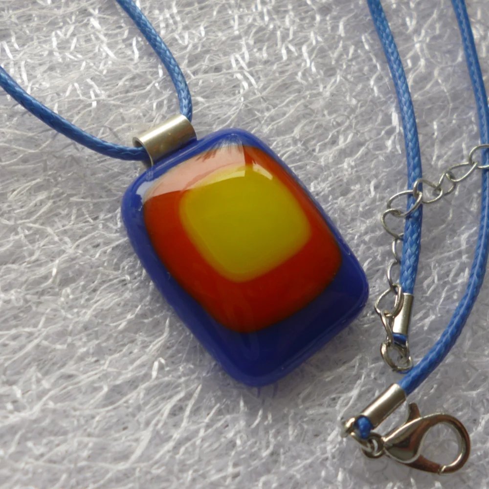 Rectangle blue, red and yellow stack pendant with blue cord necklace and extension chain.