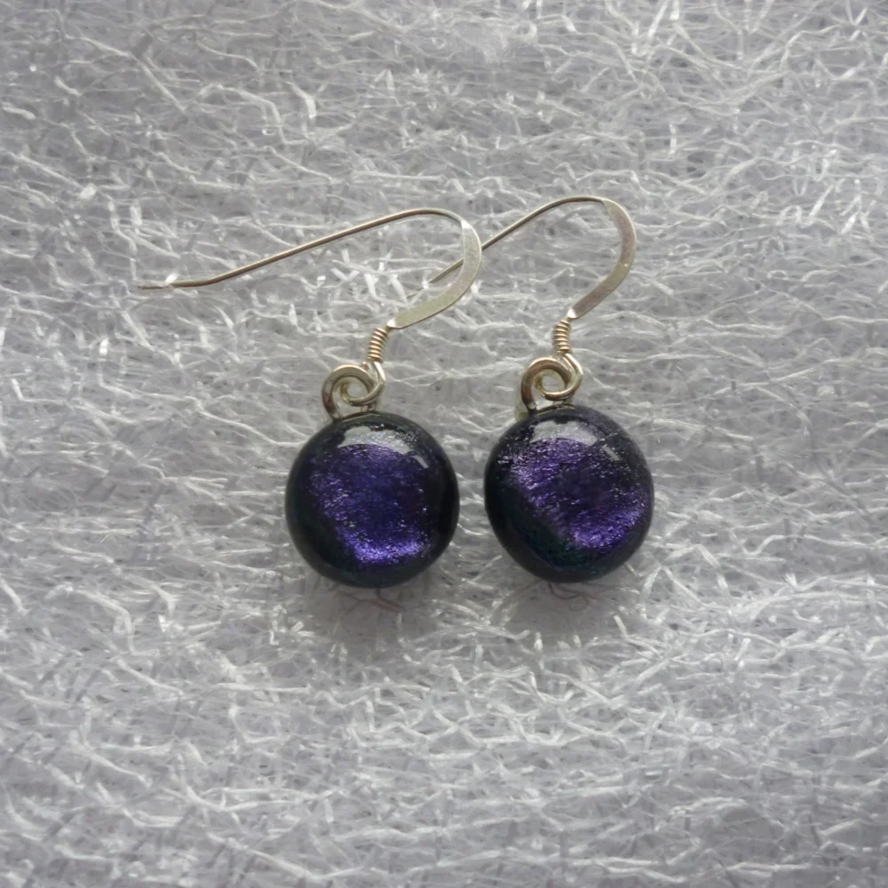 Earrings with purple dichroic glass cabochons attached to silver plated bails and 925 sterling silver ear wires.