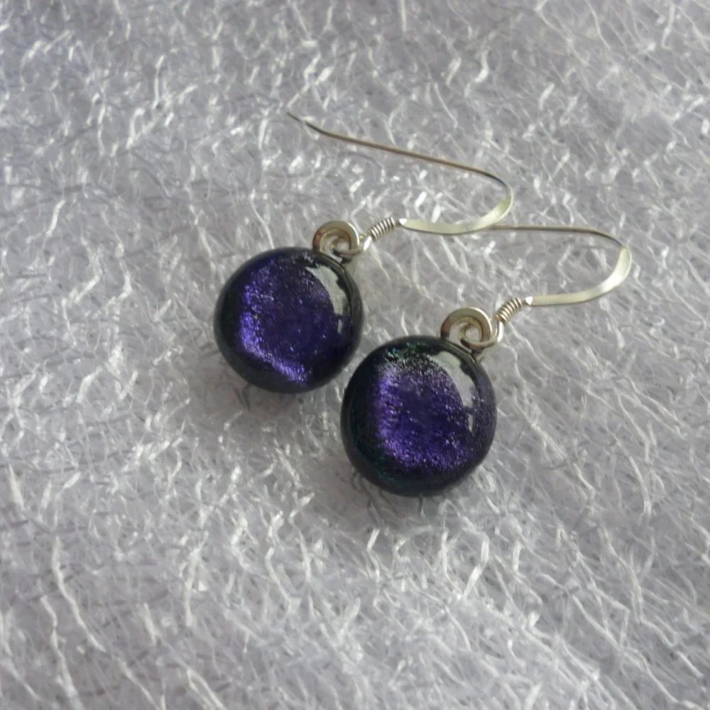 Purple dangle earrings with cabochons attached to silver plated bails and 925 sterling silver ear wires.