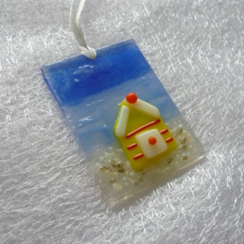 Side view of small suncatcher is very tactile, with a hole at the top and a white ribbon threaded through.