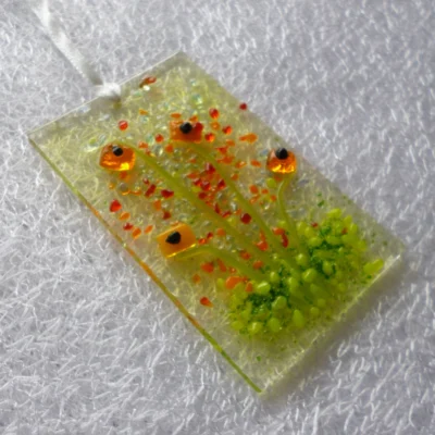 Side view of tactile orange flower suncatcher from a different angle.
