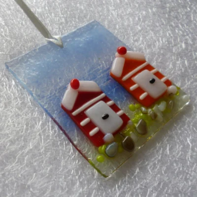 Tactile beach huts in red and orange with white stripes. Coastal design in fused glass hanging from a white ribbon.