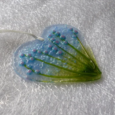 Side view and different angel of blue flower heart glass suncatcher.