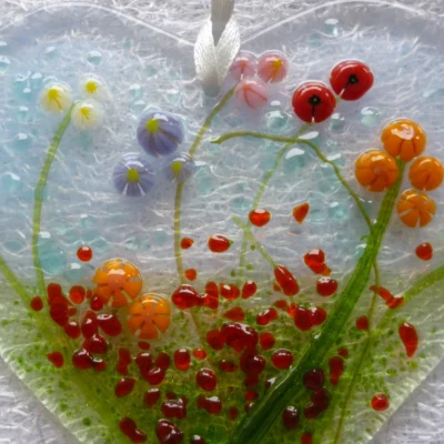 Close up of vibrant tactile fused glass beads to represent flowers.