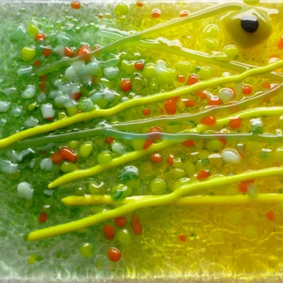 Close up of long stems on fused glass suncatcher.