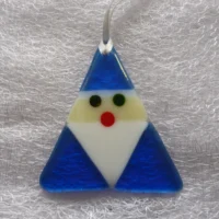 Unique blue iridised glass Santa in a triangular shape, with a white beard and red nose hanging from a white ribbon. The irid glass gives Santa a little bit of a shimmer