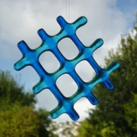 Two shades of blue lattice fused glass suncatcher. Suncatcher made with six pieces of glass laid in a lattice design.