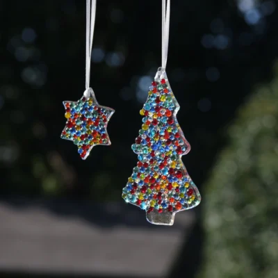 Fused glass colourful Christmas tree and star at an angle.