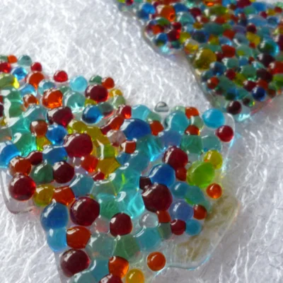 Side view of Christmas tree suncatchers with all the colourful beads.