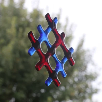 Side view of lattice red and blue fused glass suncatcher.