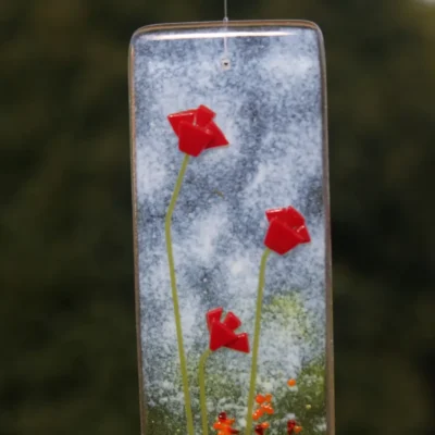 Close up of three tactile red flowers at the top of the suncatcher