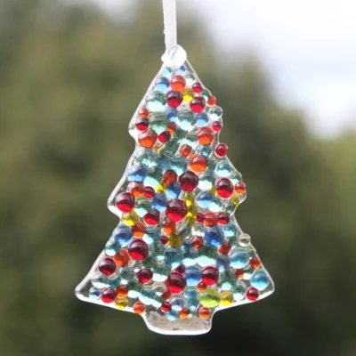 Single fused glass Christmas tree suncatchers with colourful glass beads on top, hanging from a white ribbon.