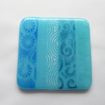 Single square blue fused glass coaster, with enamel printer, streaky, powder printed glass.