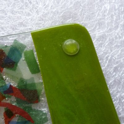 Back of green coaster showing bumper to protect furniture.