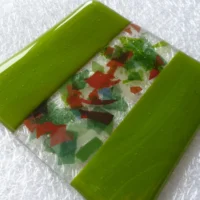 Handmade green coaster laying at an angle.