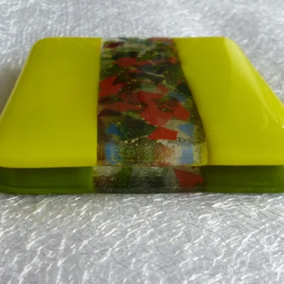 Yellow and green fused glass coasters stacked.
