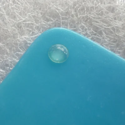 Back of blue fused glass coaster showing bumper to protect furniture.