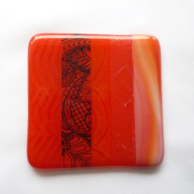 Single square red fused glass coaster, with enamel printer, streaky, powder printed glass.