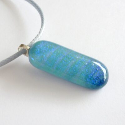 Blue handmade dichroic glass pendant with sterling silver bail and grey cord necklace.