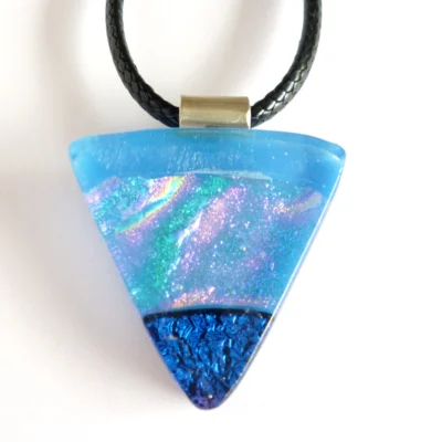Triangular blue dichroic glass pendant showing turquoise pink and gold shimmer