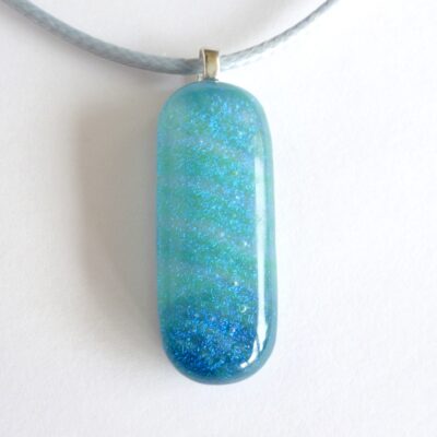 Blue dichroic glass pendant with sterling silver bail and grey cord