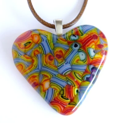 Close up of handmade fused glass pendant with sterling silver bail