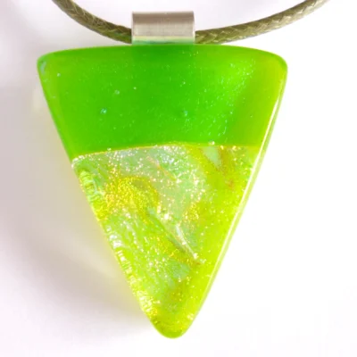 Close up of handmade green dichroic fused glass pendant with sterling silver bail