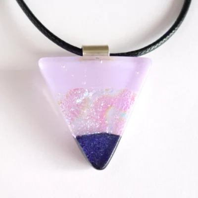 Lilac fused dichroic glass pendant on a white background