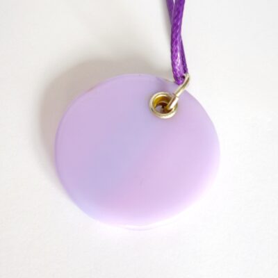 Back view of round lilac dichroic glass pendant with sterling silver grommet