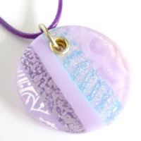 Lilac dichroic glass pendant with sterling silver fitting at an angle