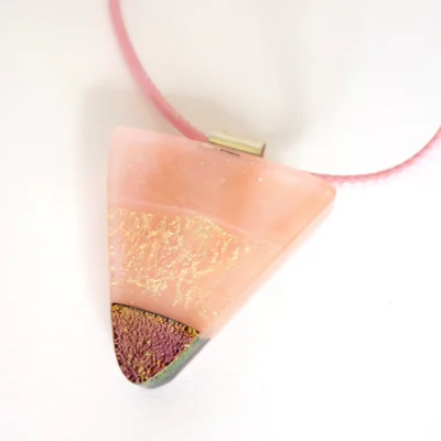 Pink dichroic pendant necklace showing depth of glass