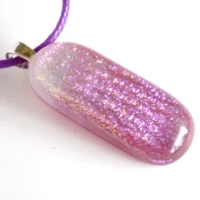 Side view of handmade purple and pink dichroic glass pendant with sterling silver bail