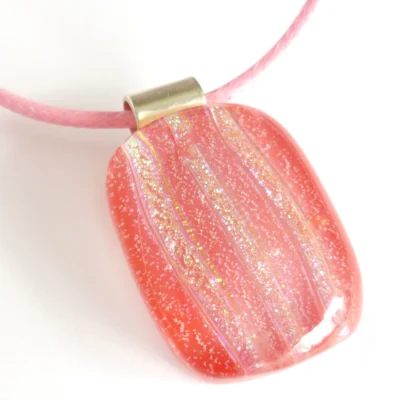 Pink dichroic glass pendant necklace on pink cord