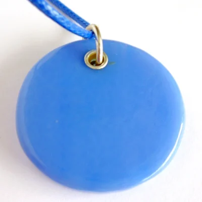 Back view of round blue dichroic glass pendant with sterling silver grommet