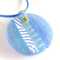 Large blue dichroic glass pendant necklace with striped detail on blue cord