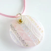 Large pale pink dichroic glass pendant necklace with striped detail on pink cord