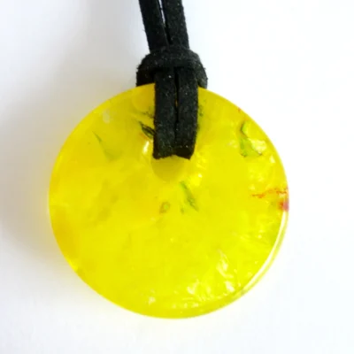Back of yellow donut fused glass pendant with black cord necklace