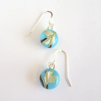 Reactive glass earrings at a different angle.