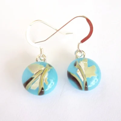 Fused reactive glass earrings in blue with brown and tan pattern. Sterling silver ear hooks attached.