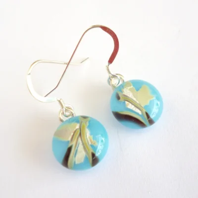Blue reactive glass earrings with unique pattern on top and sterling silver ear hooks.