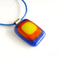 Handmade blue red and yellow fused glass pendant with blue cord necklace