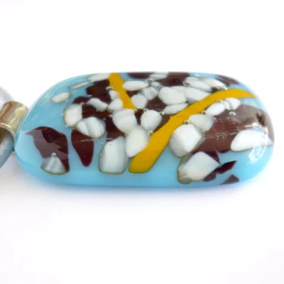 Side view of blue and white reactive glass pedant necklace showing depth