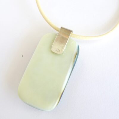 Back of pendant with sterling silver bail and cream cord necklace