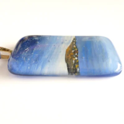 Side view of fused glass seascape pendant showing depth of glass
