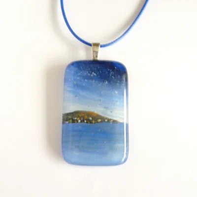 Hand-painted blue fused glass seascape pendant with sterling silver bail and blue cord necklace