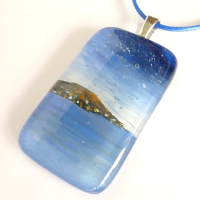 Fused glass seascape pendant in blue with sterling silver bail and blue cord necklace