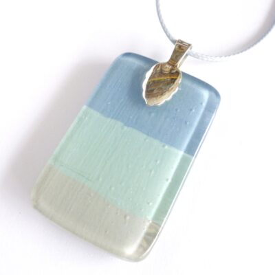 Back of seascape pendant with sterling silver bail attached with grey cord necklace